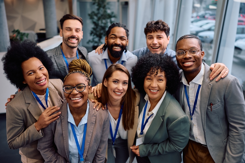 Portrait,Of,Happy,Multiracial,Business,Team,At,Convention,Center,Looking
